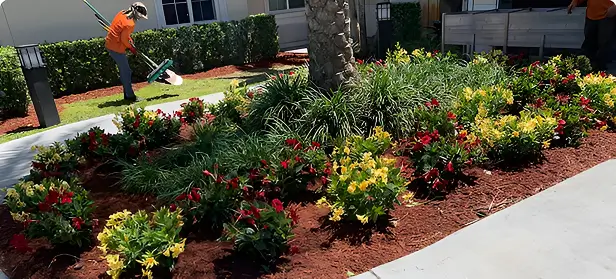 Worker Shoveling Soil In Garden Bed
